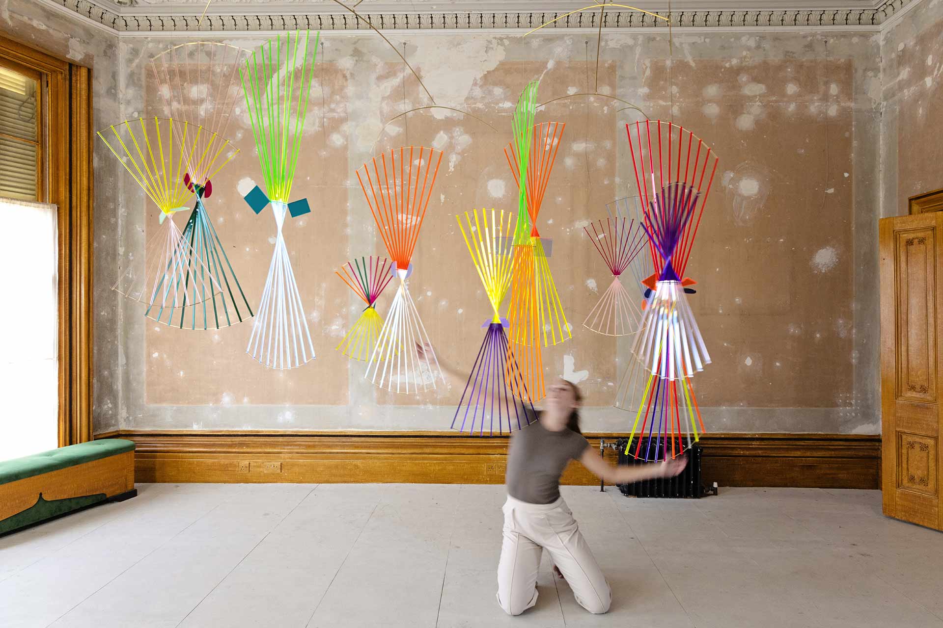 A dancer looking up at an immersive art piece by Claire Knill.